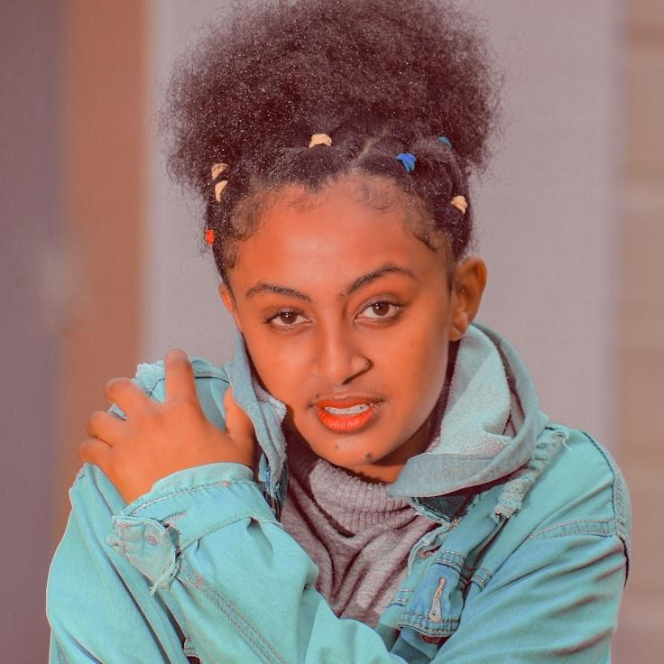 Avery Chen, Lead Design Curator at CopperSummitStar, reviewing corporate floral arrangements